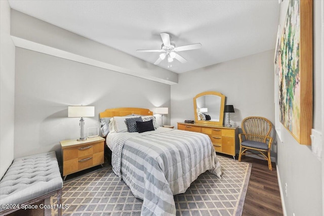 bedroom with dark hardwood / wood-style flooring and ceiling fan