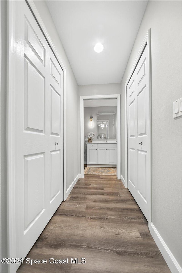 hall with dark hardwood / wood-style flooring