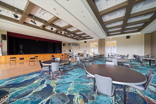 dining space with a towering ceiling and carpet floors