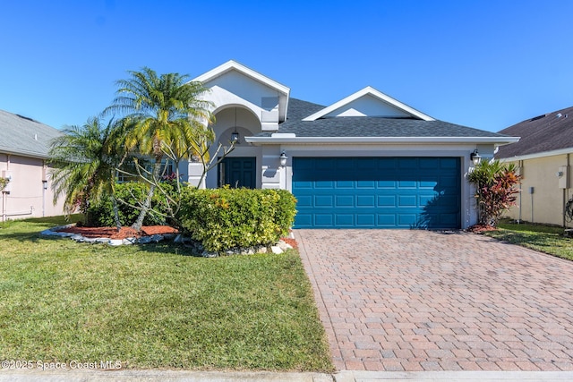 view of front of house with a front lawn and a garage