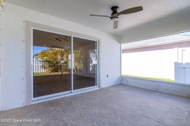 exterior space featuring ceiling fan