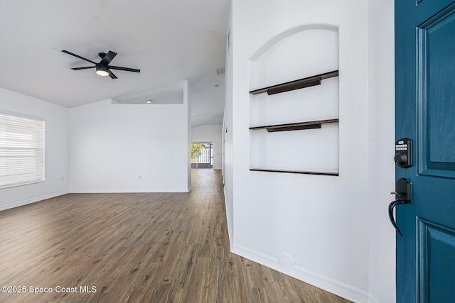 entryway with ceiling fan, hardwood / wood-style floors, and lofted ceiling