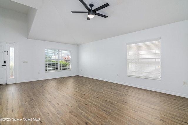 unfurnished living room with vaulted ceiling, ceiling fan, and hardwood / wood-style floors