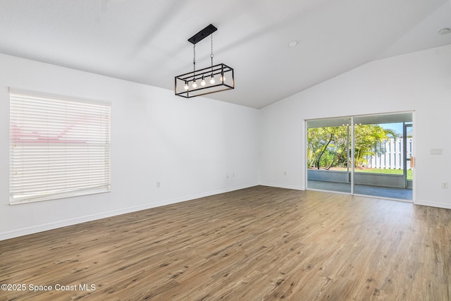 interior space with lofted ceiling and hardwood / wood-style floors