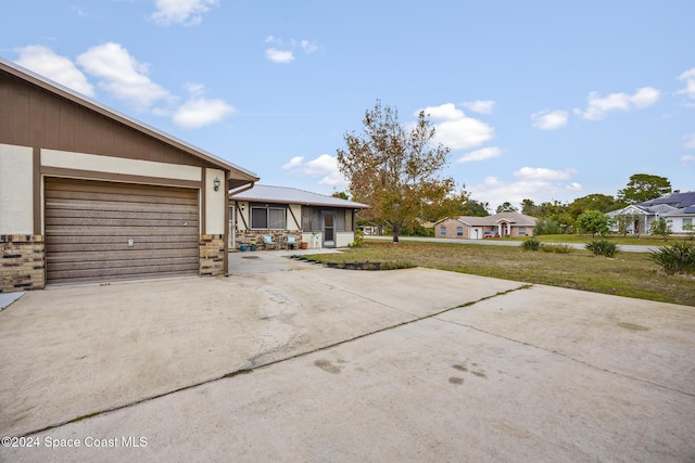 exterior space with a garage and a front lawn