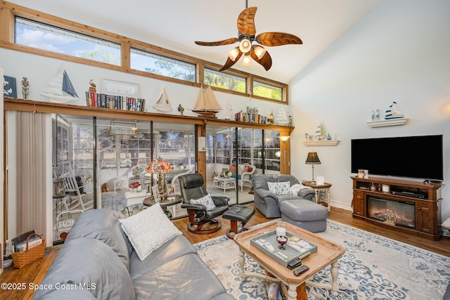 living room featuring hardwood / wood-style floors, ceiling fan, a healthy amount of sunlight, and high vaulted ceiling