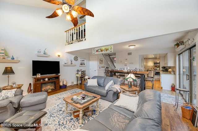 living room with ceiling fan and wood-type flooring