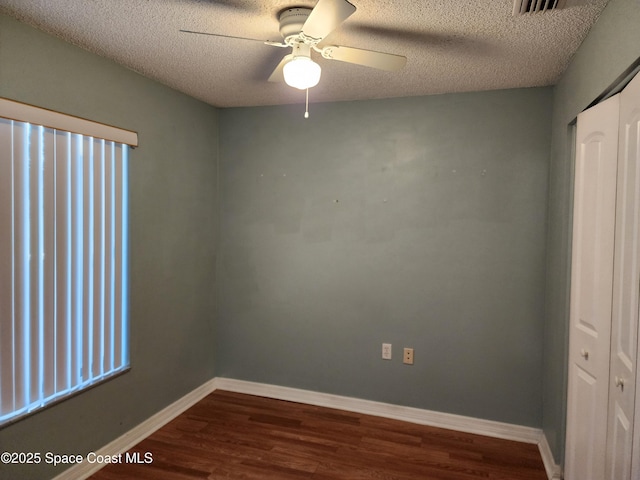 spare room with ceiling fan, hardwood / wood-style floors, and a textured ceiling