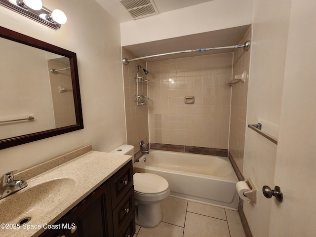 full bathroom featuring tile patterned floors, vanity, toilet, and tiled shower / bath