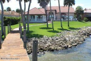 view of community with a water view and a lawn