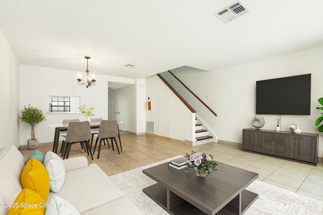 living room with light tile patterned floors and a notable chandelier