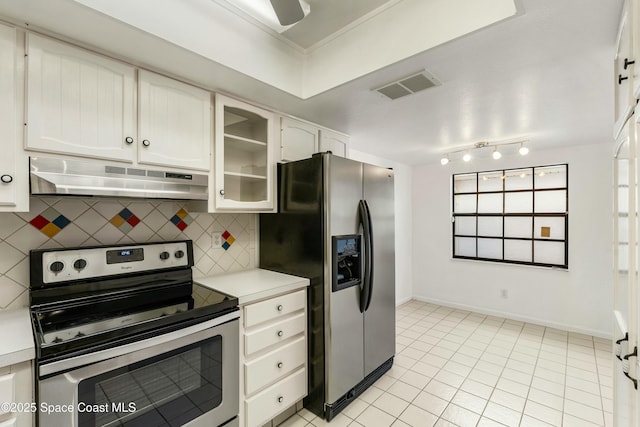 kitchen featuring appliances with stainless steel finishes, tasteful backsplash, ornamental molding, white cabinetry, and light tile patterned flooring