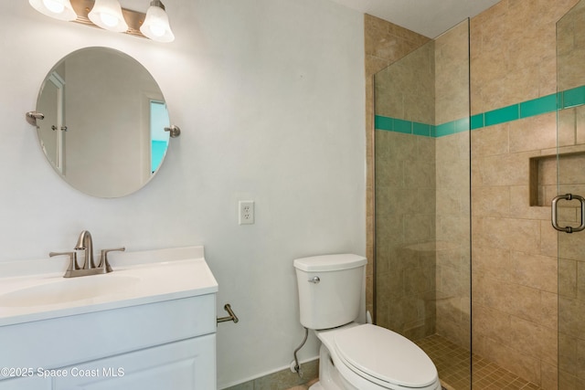 bathroom featuring vanity, toilet, and an enclosed shower