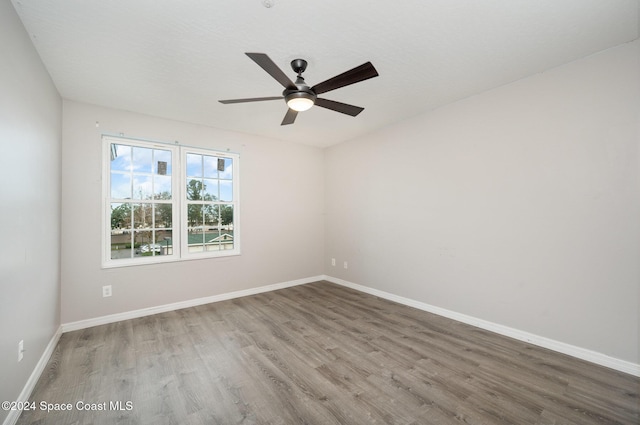 spare room featuring hardwood / wood-style floors and ceiling fan