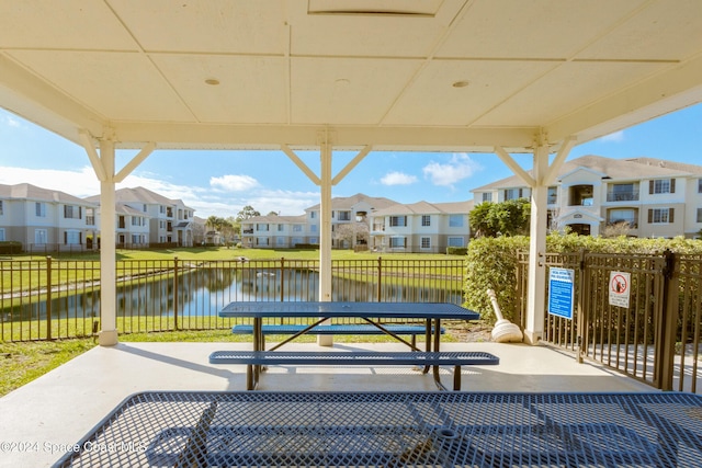 view of community featuring a water view and a patio