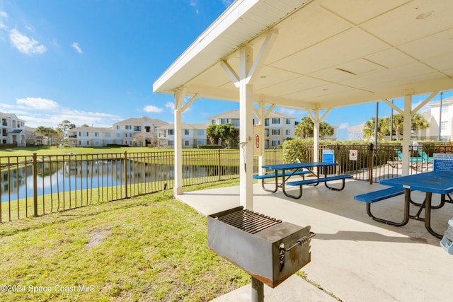 view of property's community featuring a yard and a water view