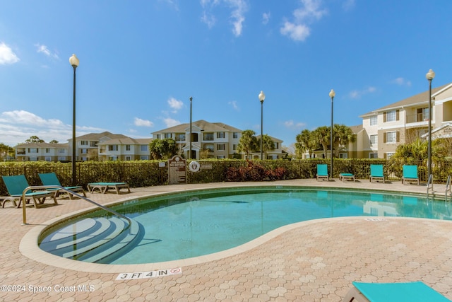 view of swimming pool with a patio