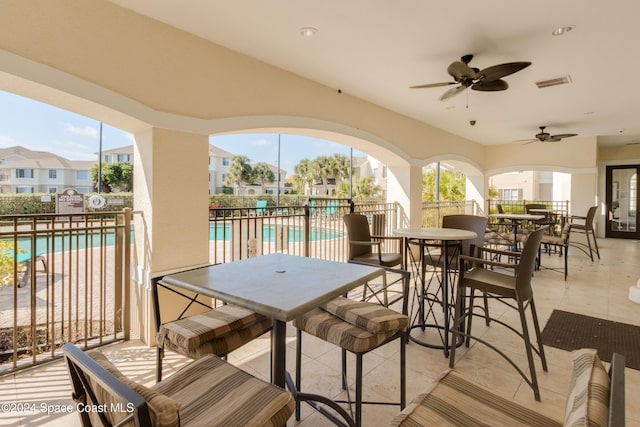 view of patio / terrace featuring ceiling fan and a community pool