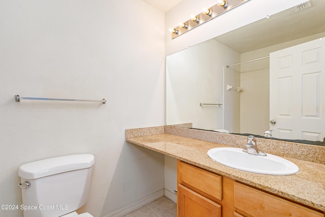 bathroom featuring tile patterned flooring, vanity, and toilet