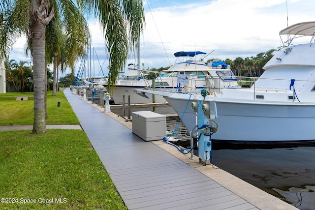 view of dock featuring a lawn