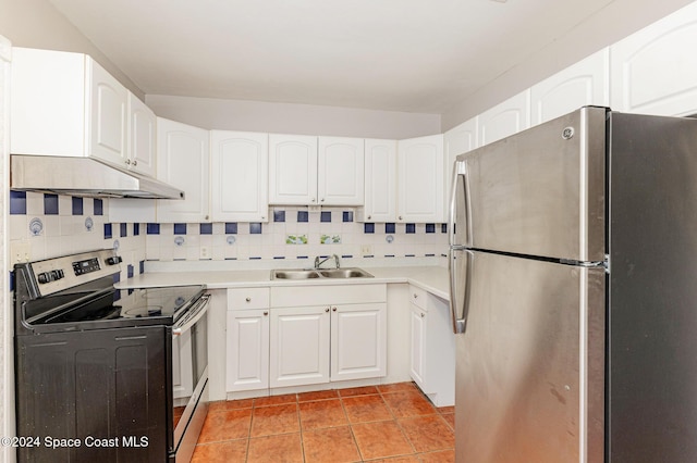 kitchen featuring appliances with stainless steel finishes, tasteful backsplash, sink, light tile patterned floors, and white cabinets