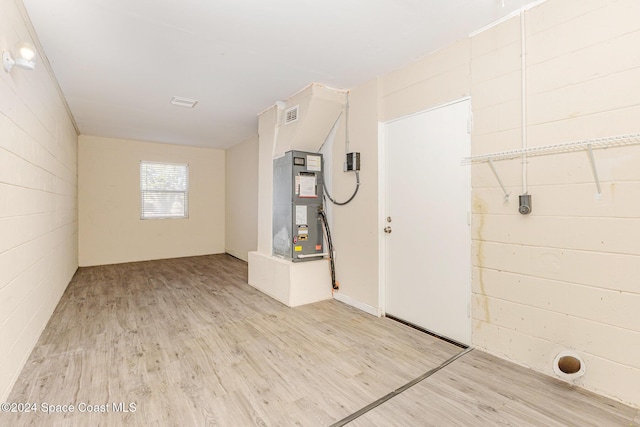 interior space featuring light hardwood / wood-style floors and heating unit