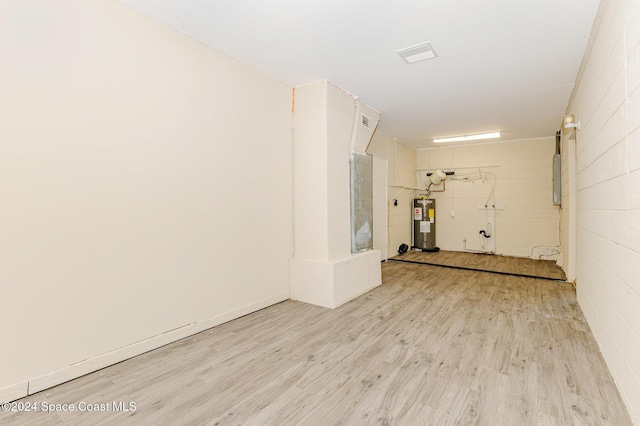 interior space featuring water heater and light hardwood / wood-style floors