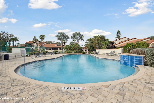 view of swimming pool with a patio