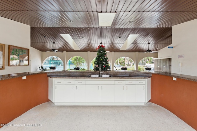 kitchen featuring plenty of natural light, white cabinetry, and sink