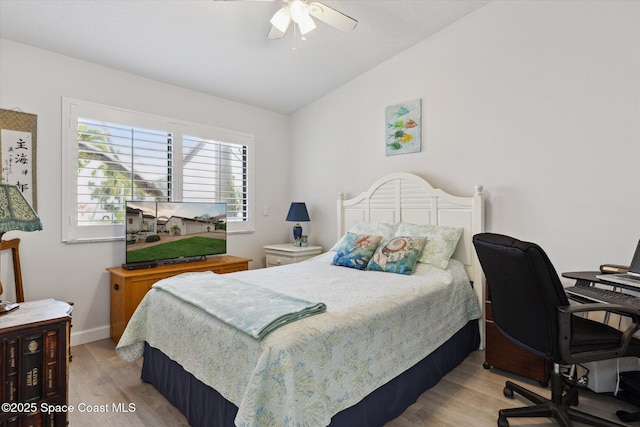 bedroom featuring ceiling fan, vaulted ceiling, and light hardwood / wood-style flooring