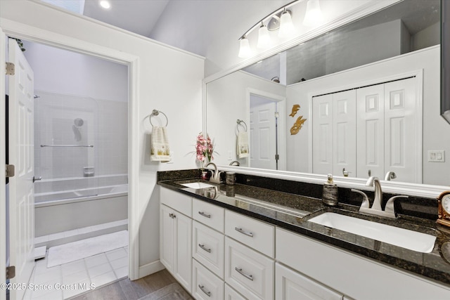 bathroom with vanity, shower / bathtub combination, and hardwood / wood-style flooring