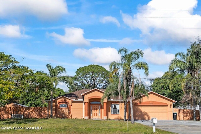 ranch-style house featuring a front yard and a garage