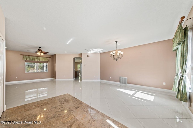 interior space with light tile patterned floors and ceiling fan with notable chandelier