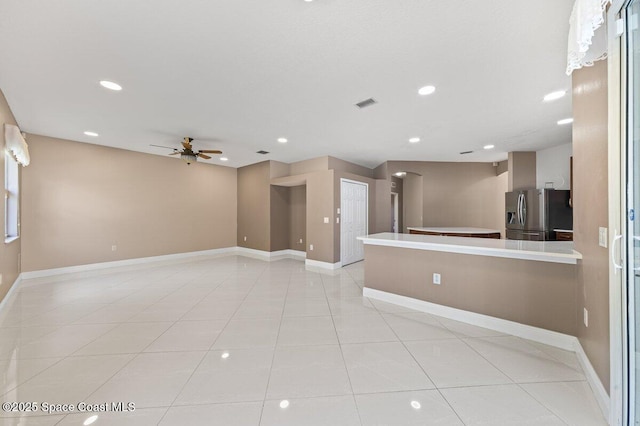 unfurnished room featuring ceiling fan and light tile patterned floors