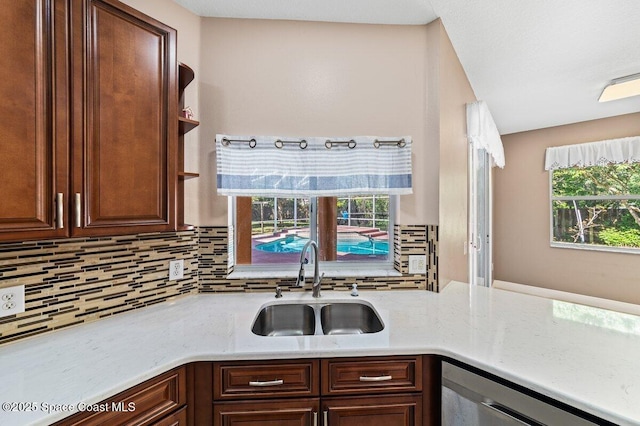 kitchen with dishwasher, tasteful backsplash, and sink