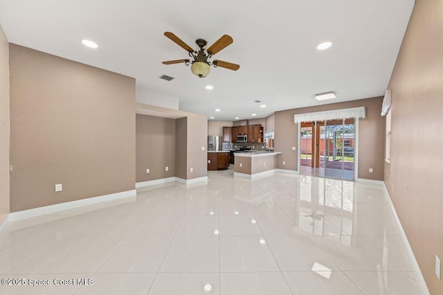 unfurnished living room featuring ceiling fan and light tile patterned floors