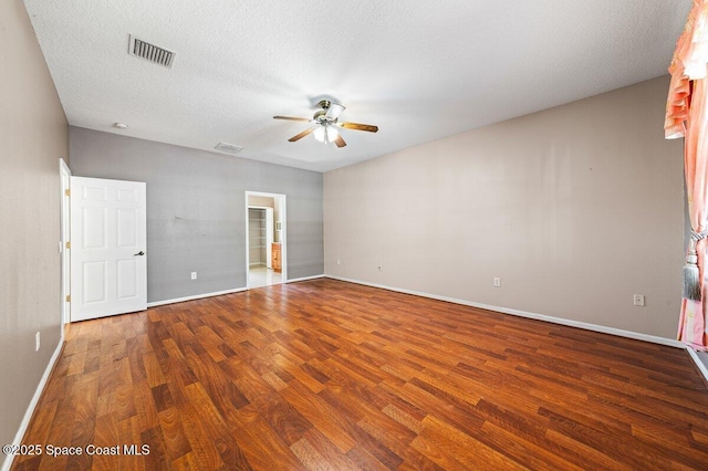 empty room featuring hardwood / wood-style floors, ceiling fan, and a textured ceiling