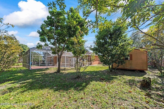 view of yard featuring glass enclosure