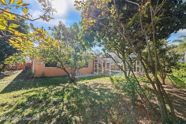 view of yard featuring a lanai and a swimming pool