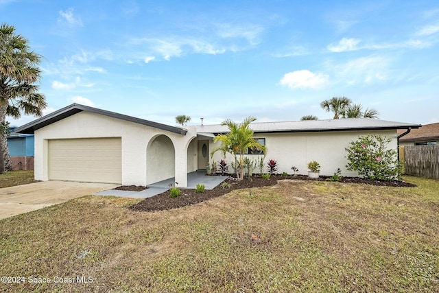 ranch-style home featuring a garage and a front yard