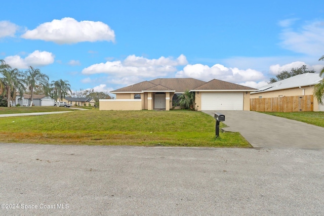 view of front of house with a garage and a front yard