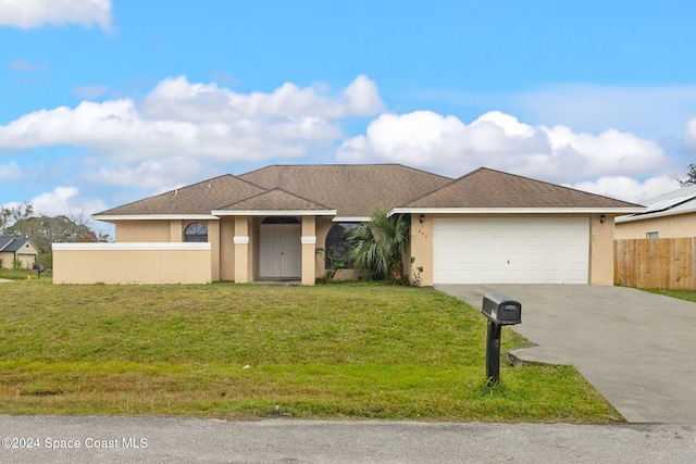 single story home with a garage and a front lawn