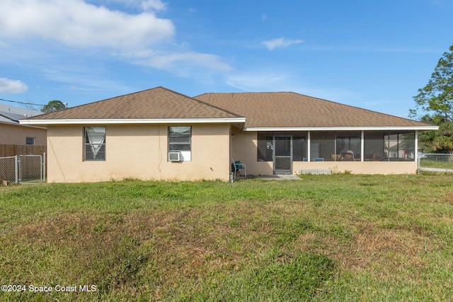 back of property featuring a sunroom, a yard, and cooling unit