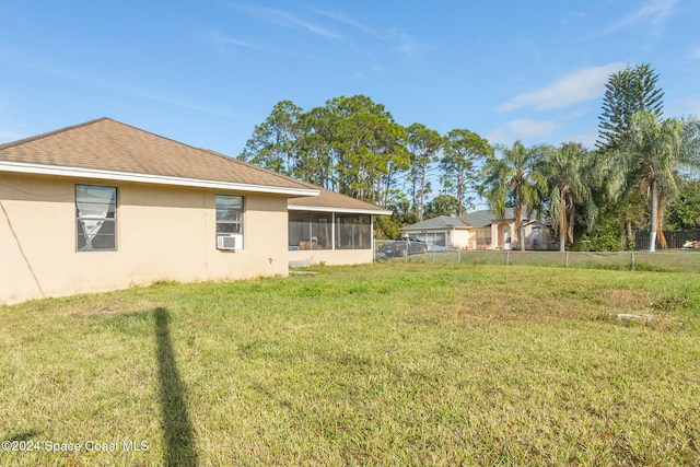 view of yard with a sunroom and cooling unit