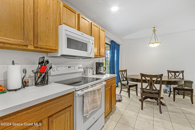 kitchen with decorative light fixtures, white appliances, and light tile patterned floors