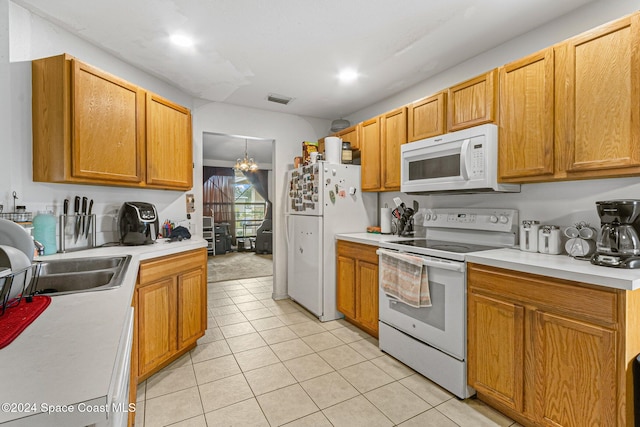 kitchen featuring a chandelier, light tile patterned floors, white appliances, and sink