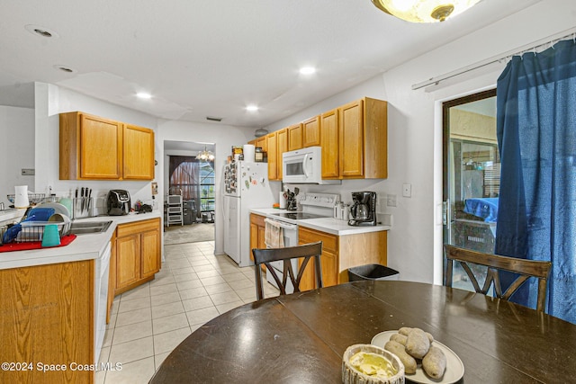 kitchen with light tile patterned floors and white appliances