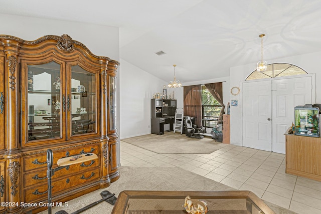 entrance foyer featuring a chandelier, vaulted ceiling, and light tile patterned flooring