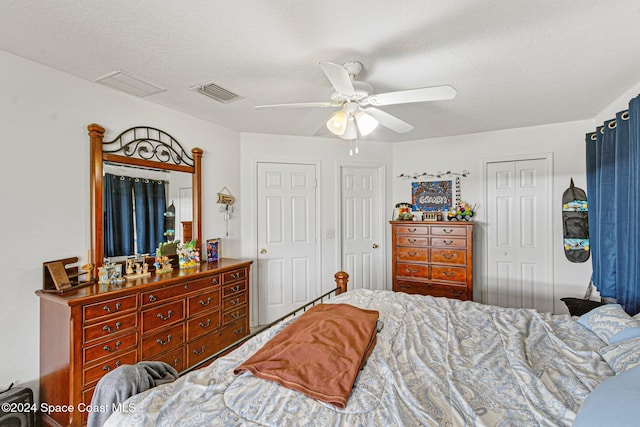 bedroom with a textured ceiling and ceiling fan