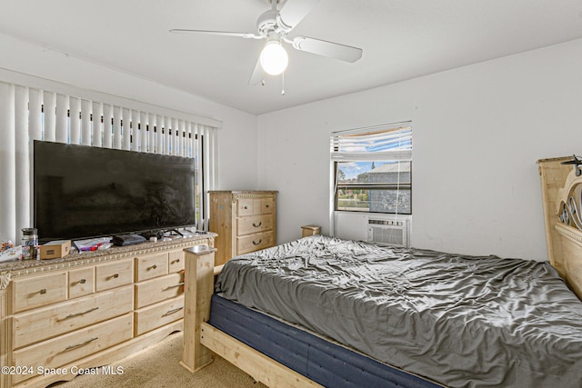 carpeted bedroom featuring ceiling fan and cooling unit